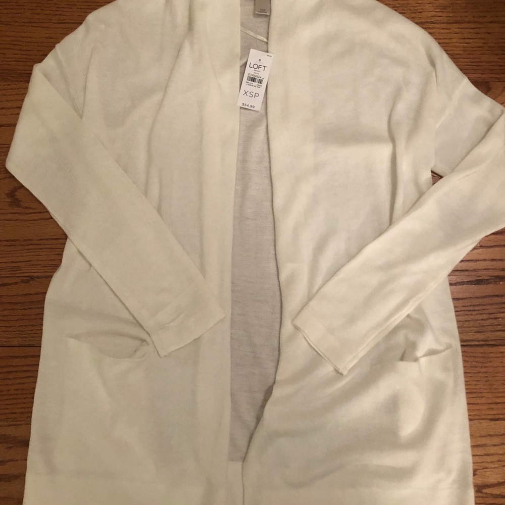 A long sleeve cardigan with pockets at the bottom.